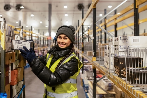 A photo of a woman working in cold conditions in a warehouse.